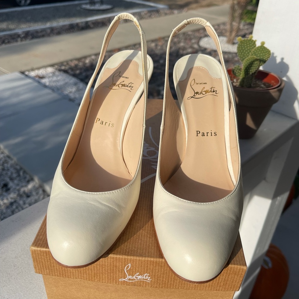 Cream Christian Louboutin heels with red bottoms